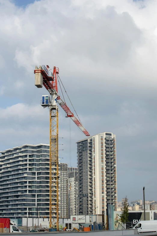 a construction site with two cranes above it