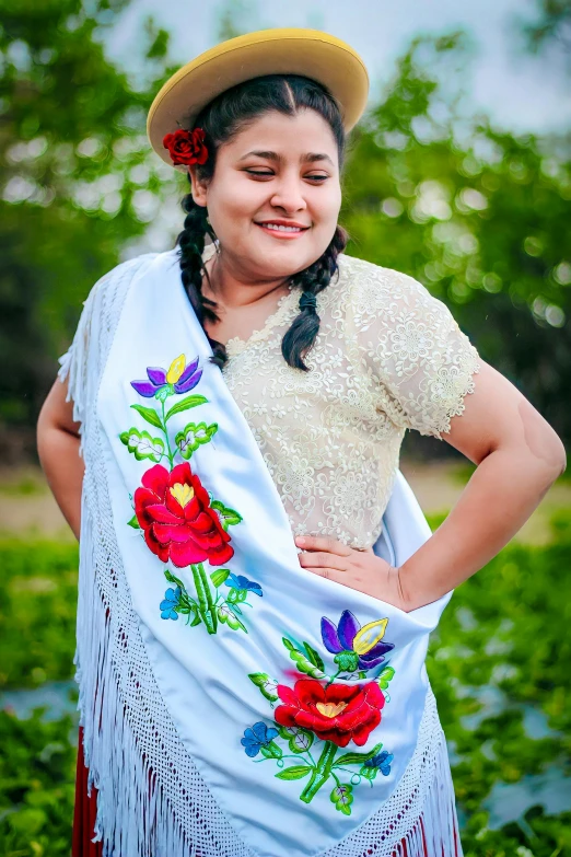 a woman in a colorfully embroidered shawl with flowers