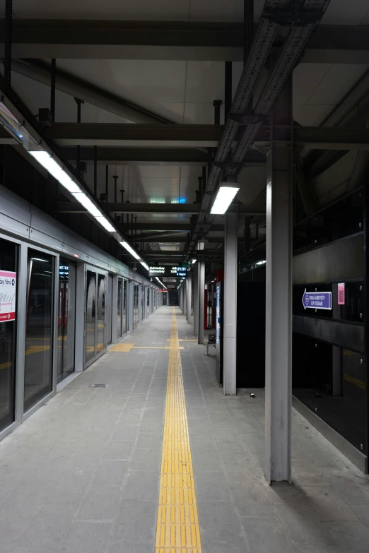 an empty subway station in a city at night