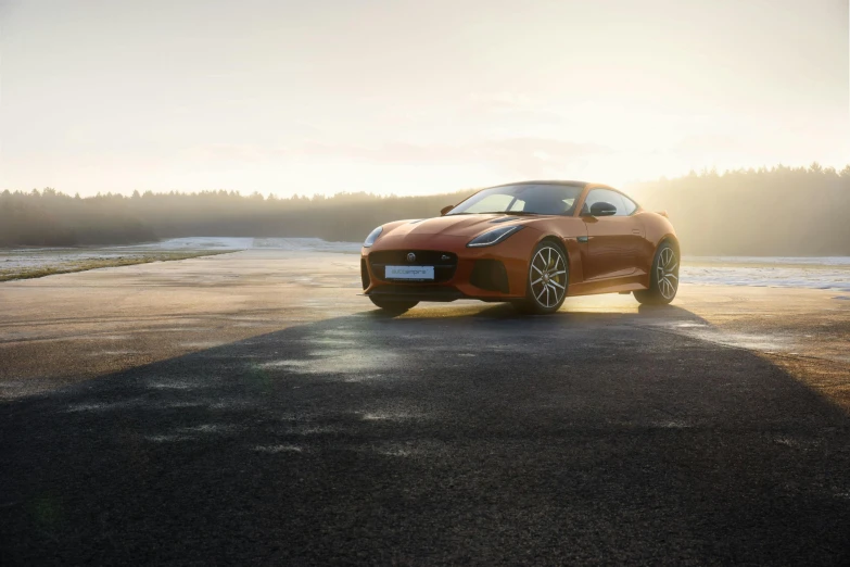 an orange sports car parked on the side of a road