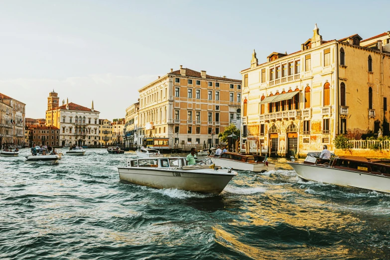 a row of boats traveling down the river