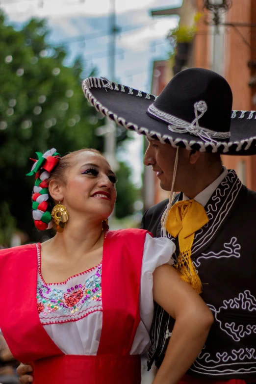 a couple in mexican attire posing for the camera