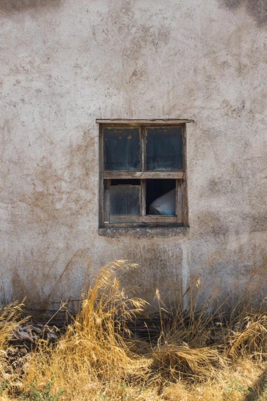 an old window of an old stucco house