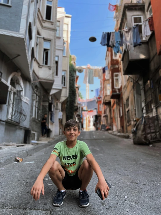 a little boy is kneeling down outside