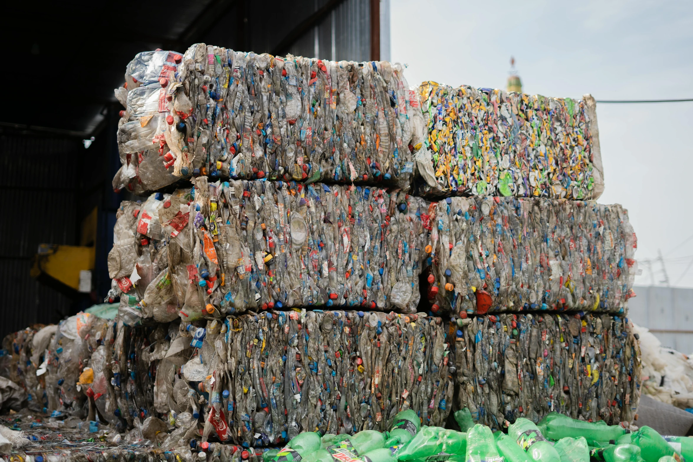 stacks of shredded plastic garbage sit in the open