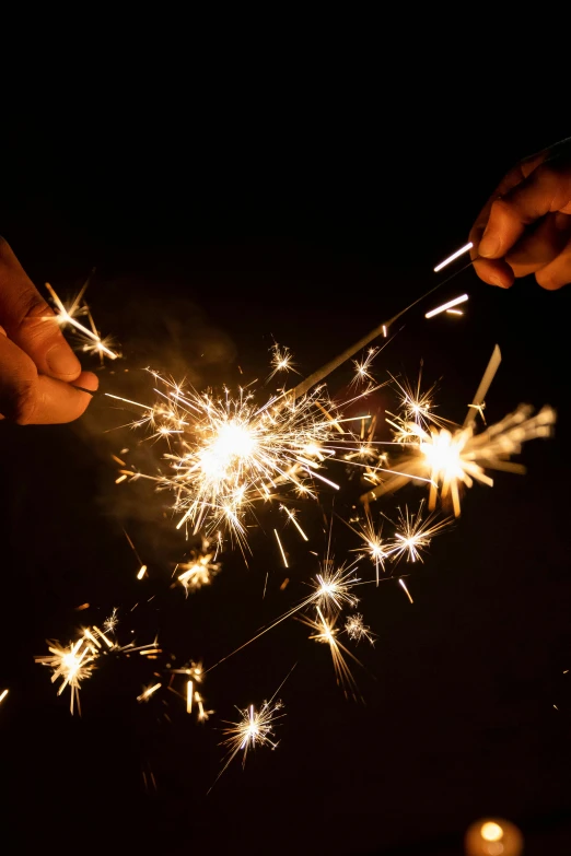 a person holding a pair of scissors with firework