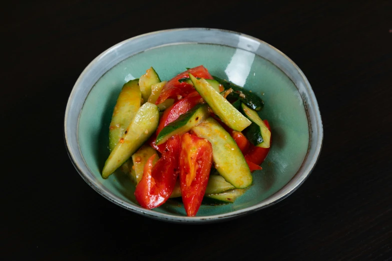 a bowl is filled with fresh chopped vegetables