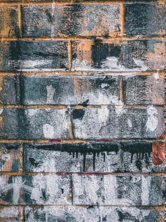 a brick wall is covered with black and white paint