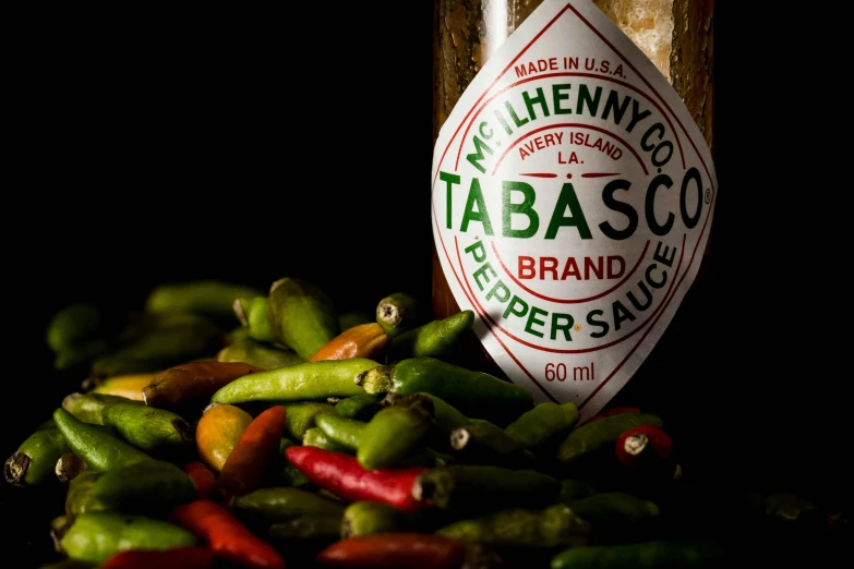 a bag of tabasco sits on top of a pile of green beans