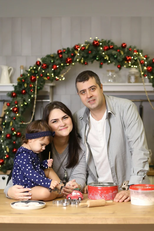 a family at christmas, posing in front of the stove