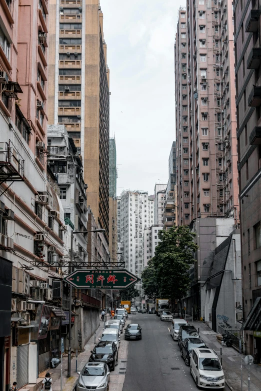 a city street is lined with cars in traffic