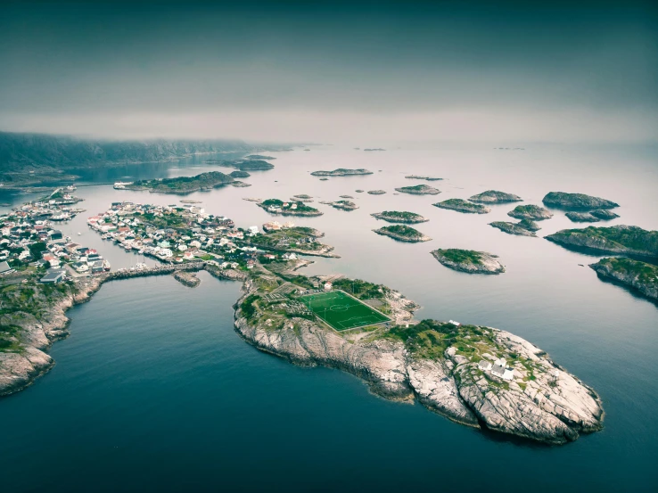 an aerial po of a lake with small islands surrounded by forest