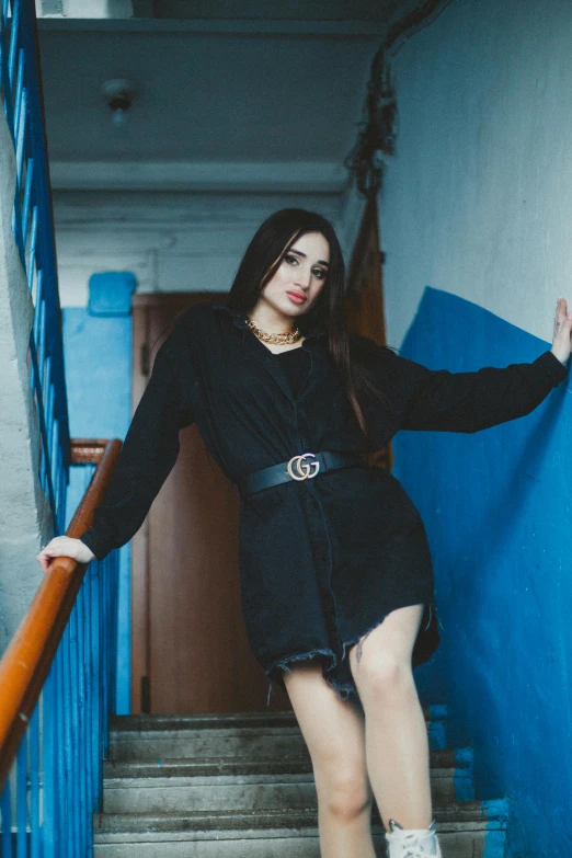 a young woman standing at the bottom of steps