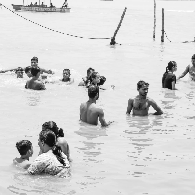 people are playing and swimming in a large pool