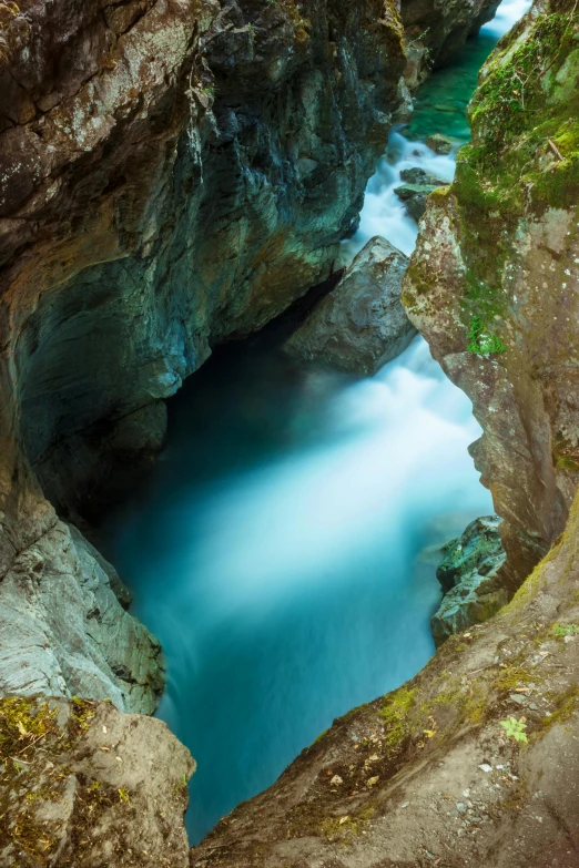 some deep water in the rocks by a large cave