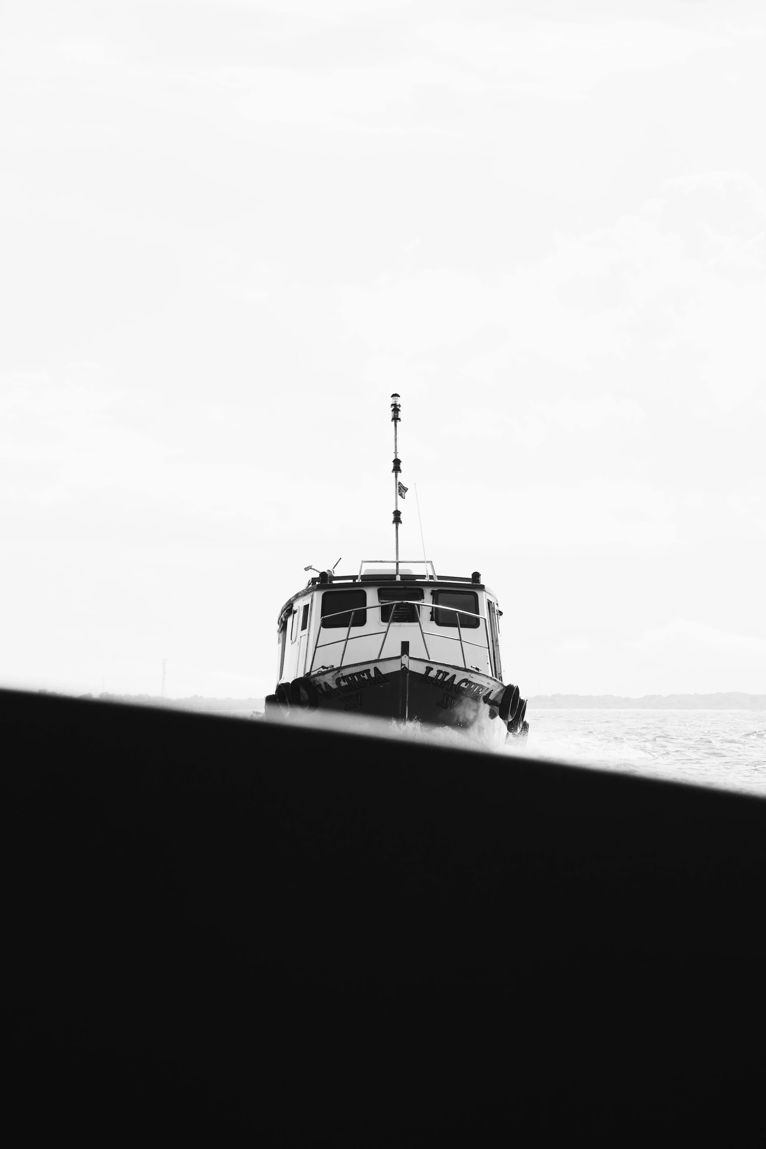 a boat sailing in the ocean in the middle of the day