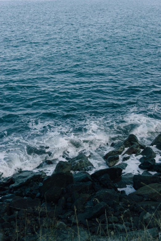 a po of some waves crashing near rocks