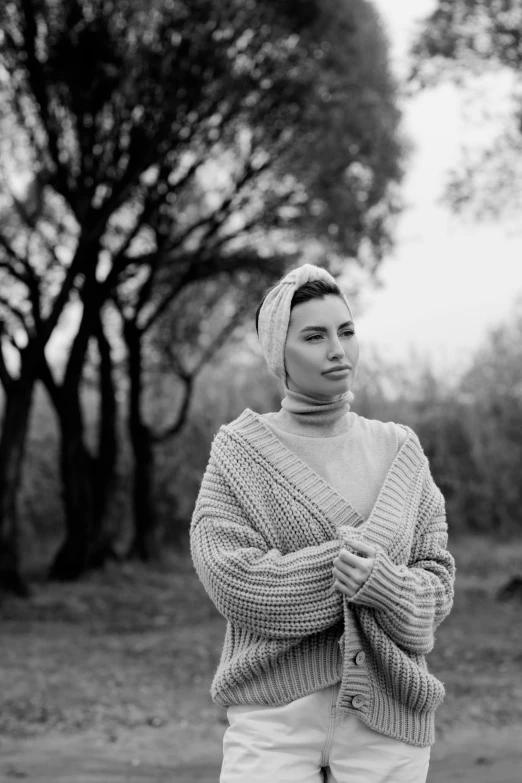 woman with sweater and a headband standing outdoors