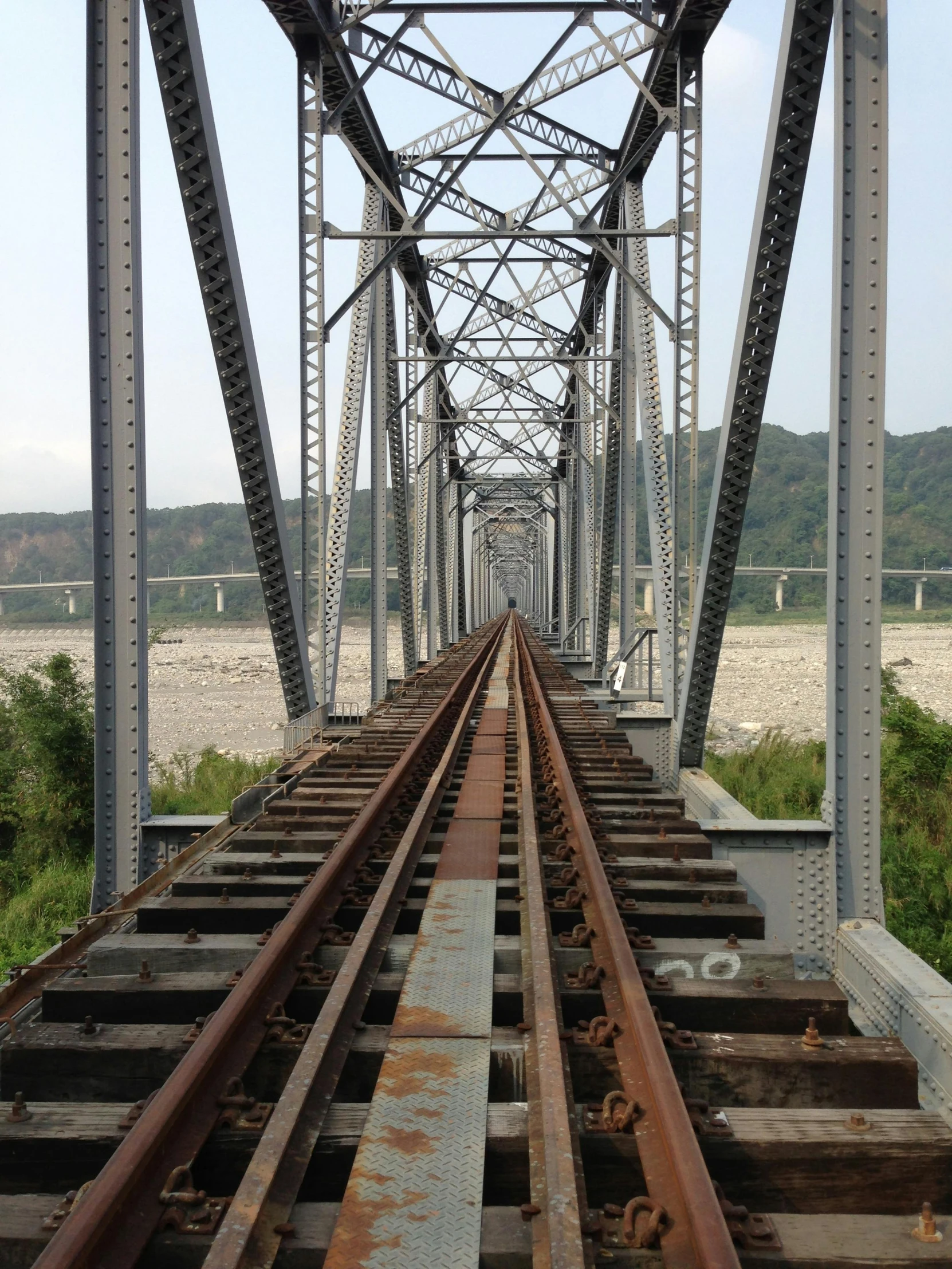 there is a railroad train on a track crossing the water