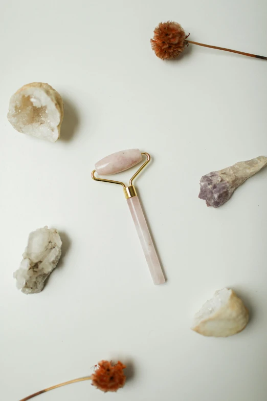 a piece of jewelry sitting next to small rocks