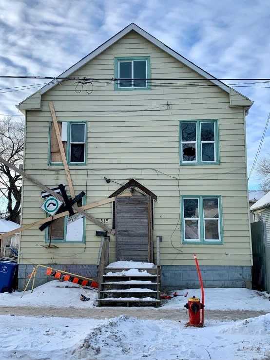 a home with snow in front and several windows