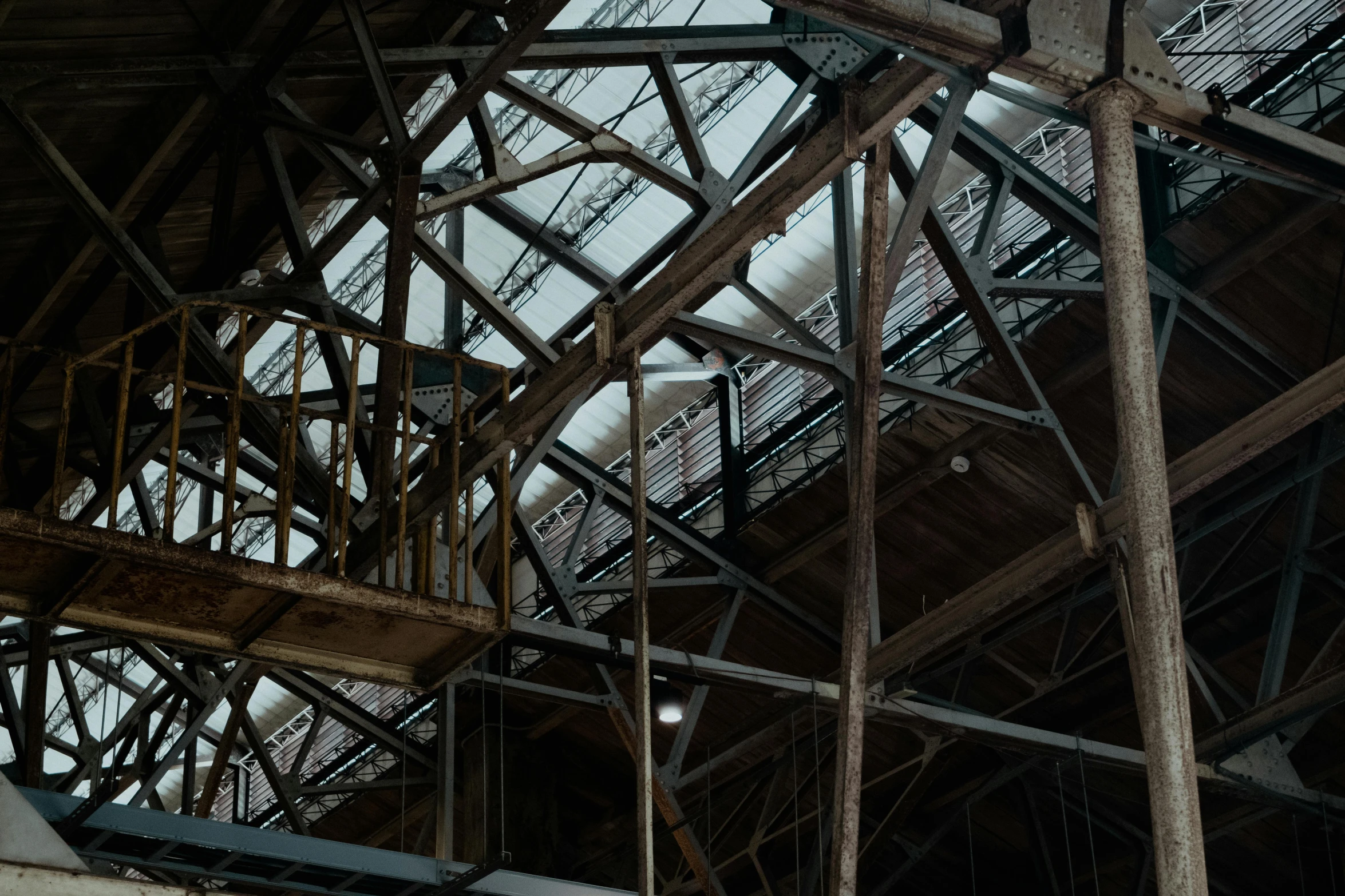 some beams and some wires in an industrial building