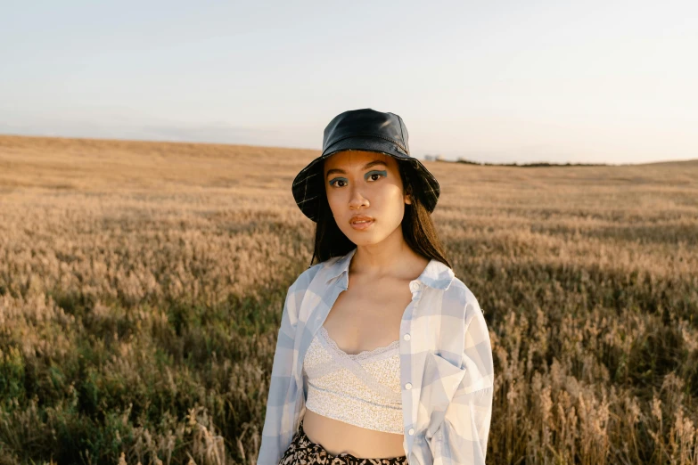 a girl with a baseball hat in a field