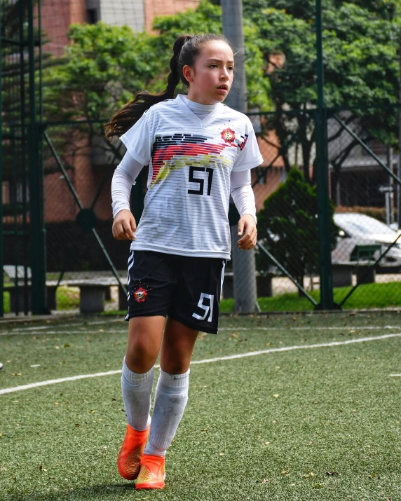 a girl in a uniform in a soccer game