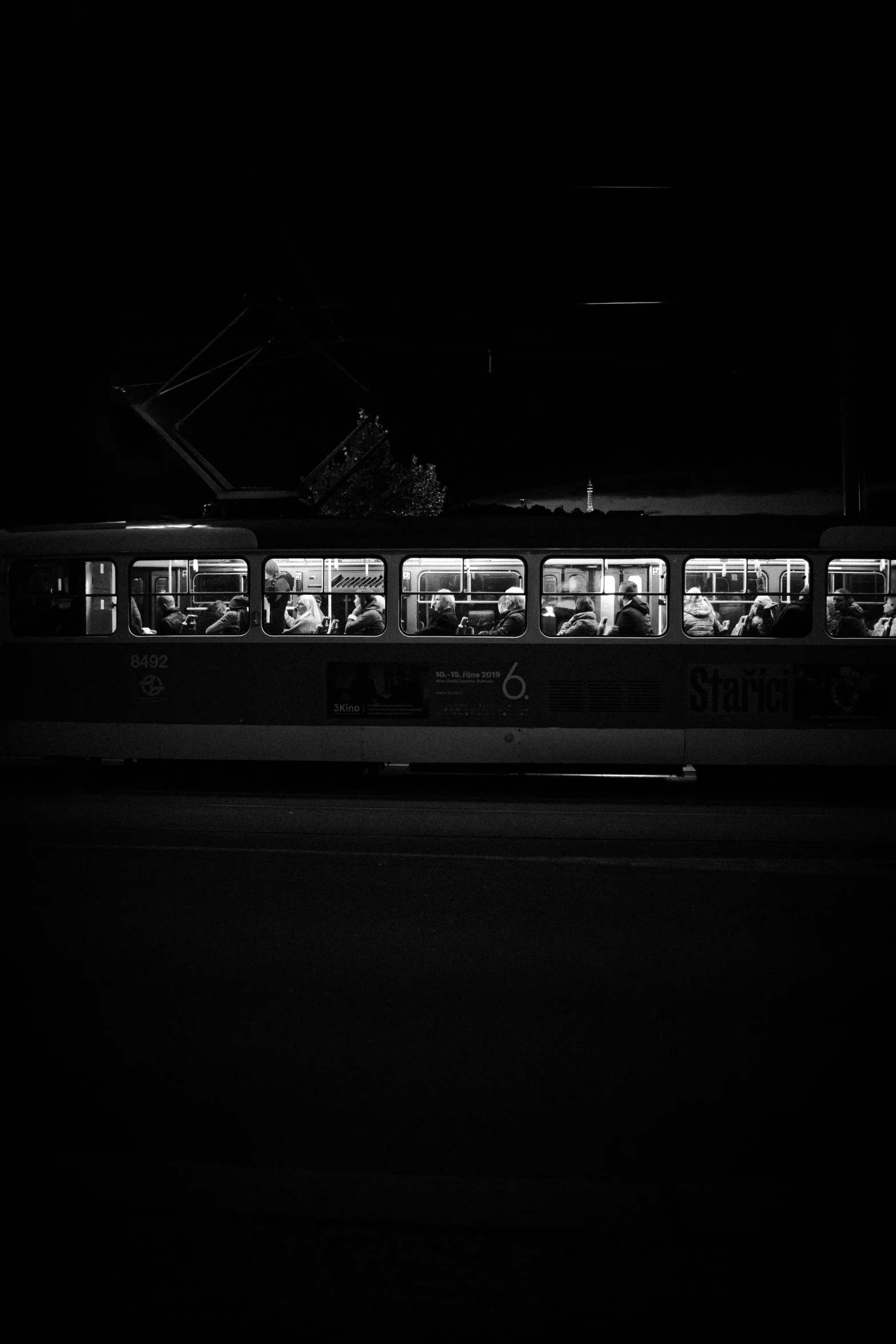 a passenger train traveling down tracks at night