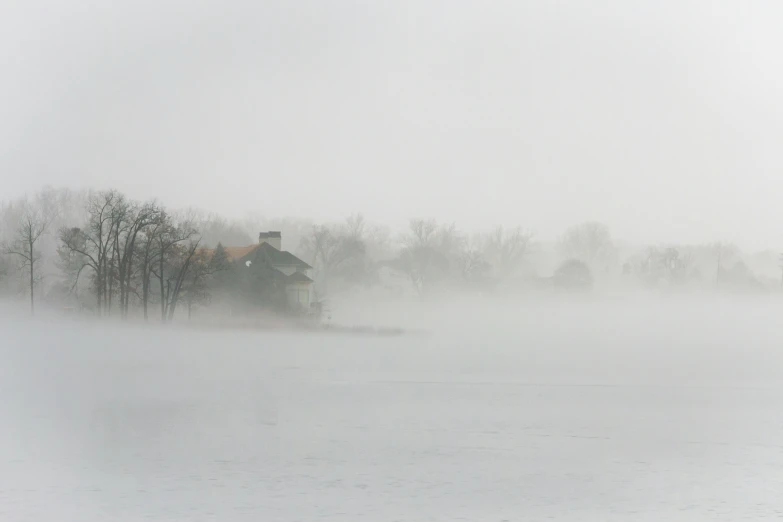 fog on water with house in the distance