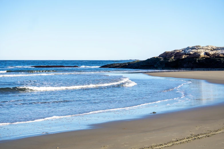 some blue water and white sand and rocks