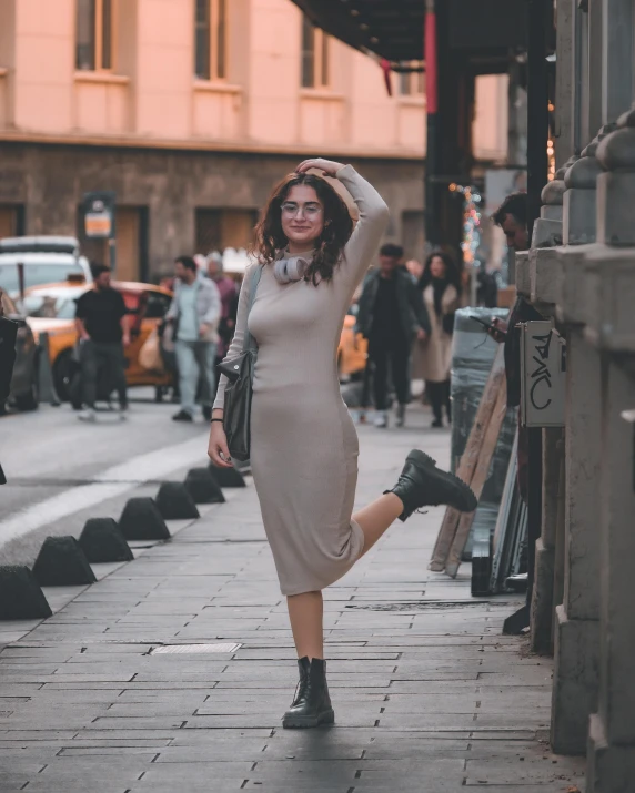 a beautiful woman walking down a street in a dress