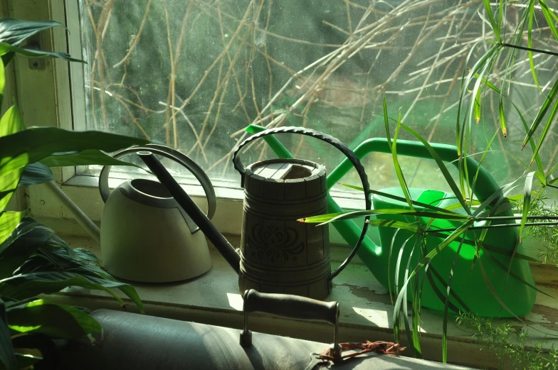 a window sill with some plants and pots