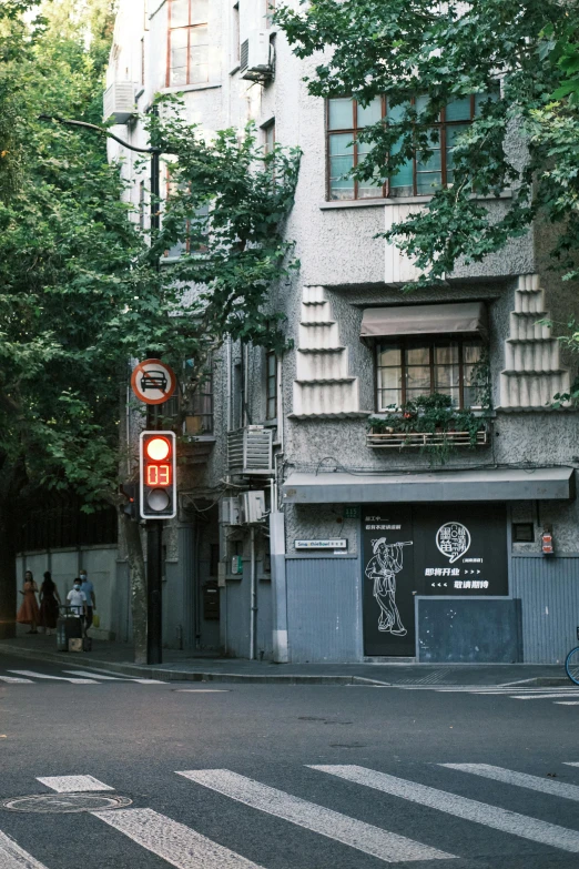 an old fashioned street light sits at the end of a quiet road