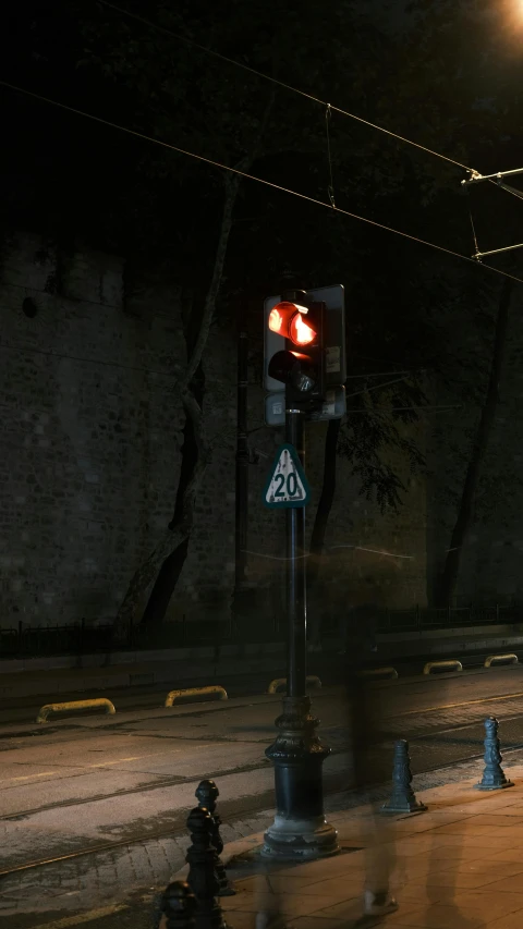a traffic light sitting above an intersection at night