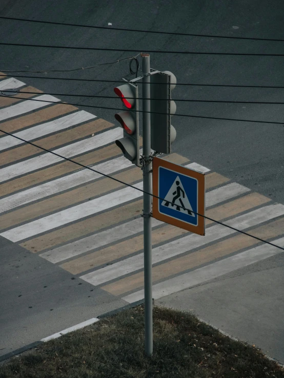 a crosswalk sign attached to a pole