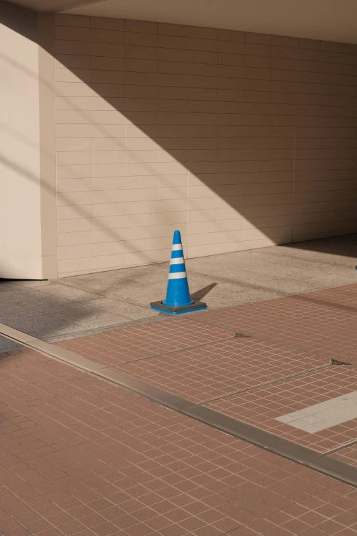 a cone sitting on the floor next to a building