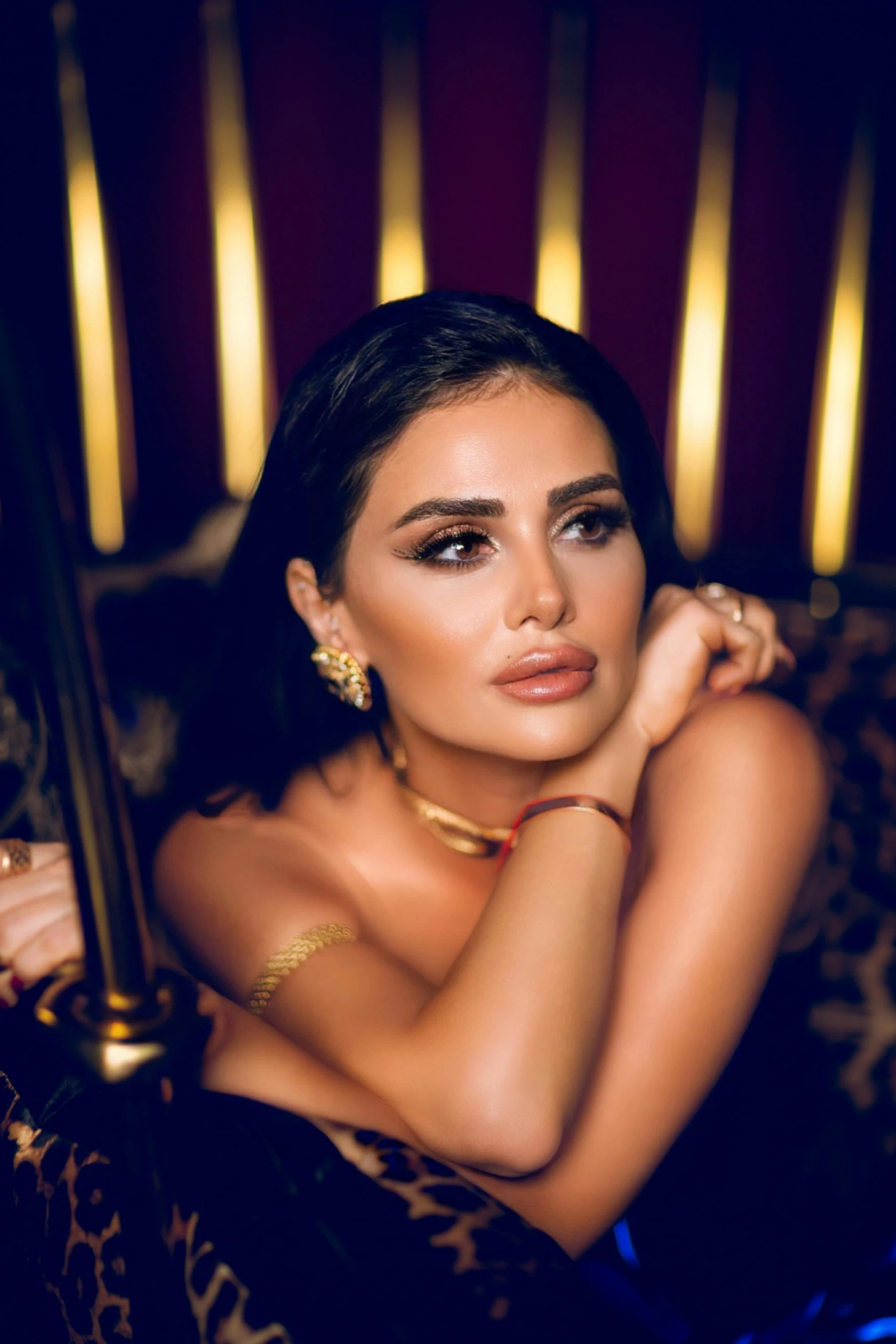 a beautiful woman sitting on top of a leopard print chair