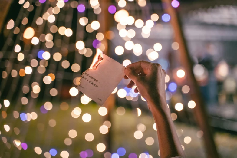 there is a woman holding a ticket to see the light