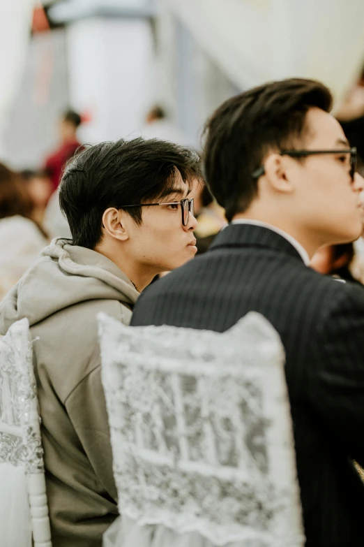 two people sitting next to each other in chairs