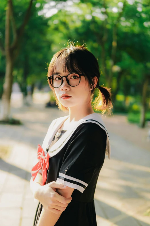 a young woman is posing on the street