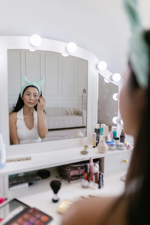 a young woman takes a po of herself in her mirror