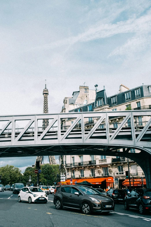 an elevated pedestrian bridge over a street in paris