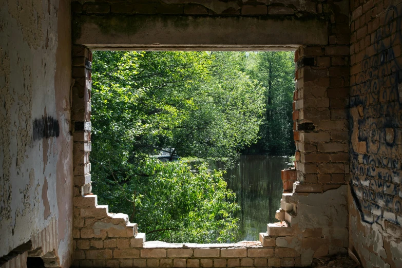 there is a view of the trees and water through a hole