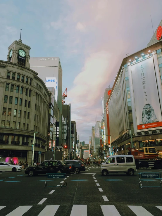 a busy city street with traffic at an intersection