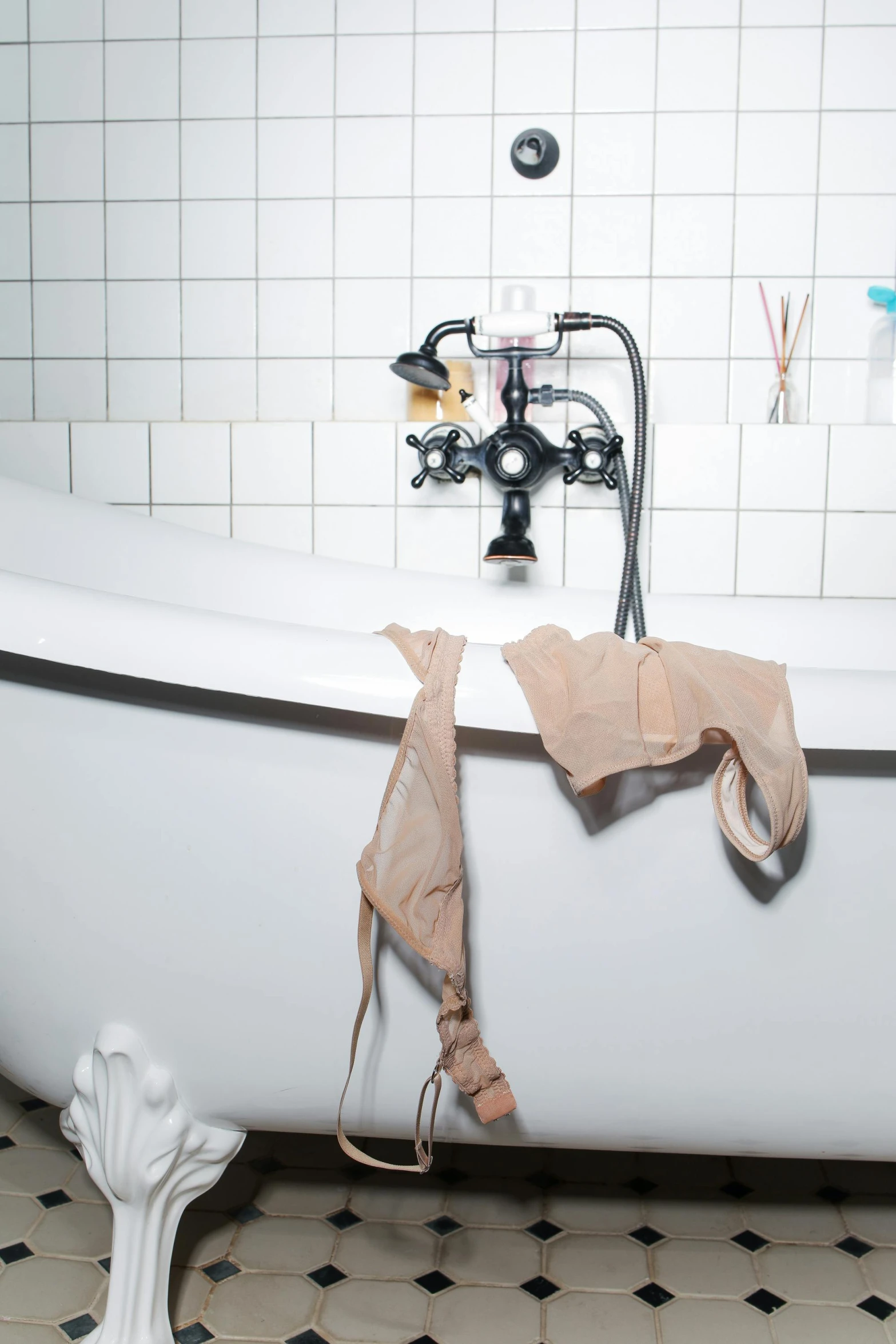 a white bath tub sitting next to a bathroom sink