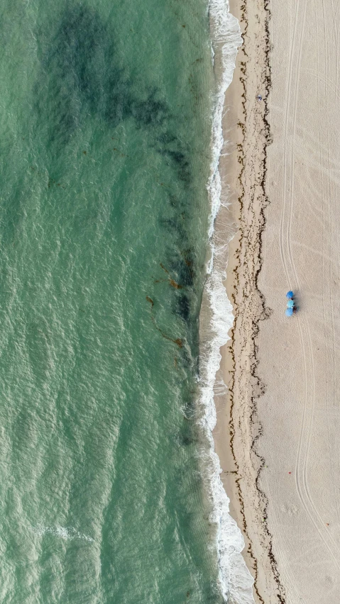 there are two people standing on the beach