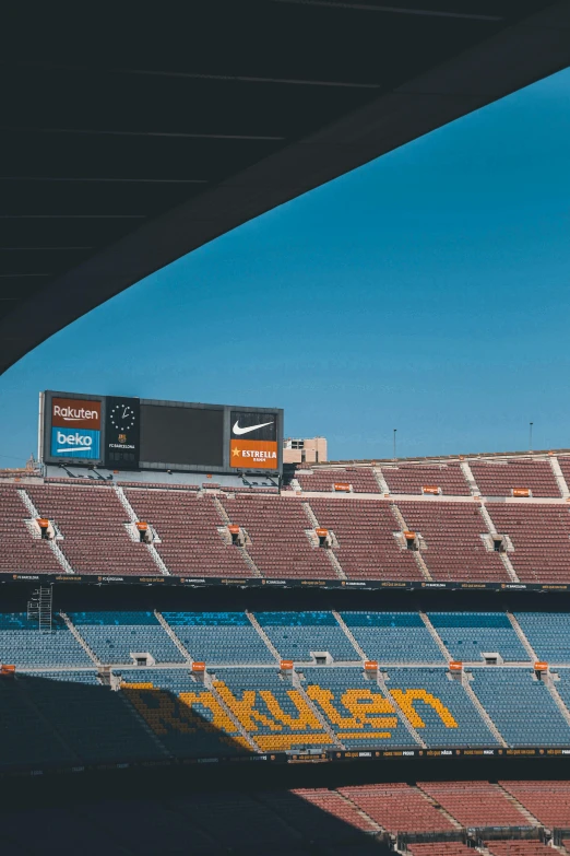 a stadium with a blue sky and white fence