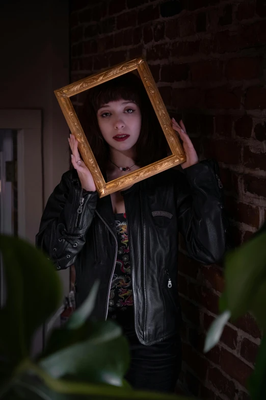 a woman is holding up a framed pograph