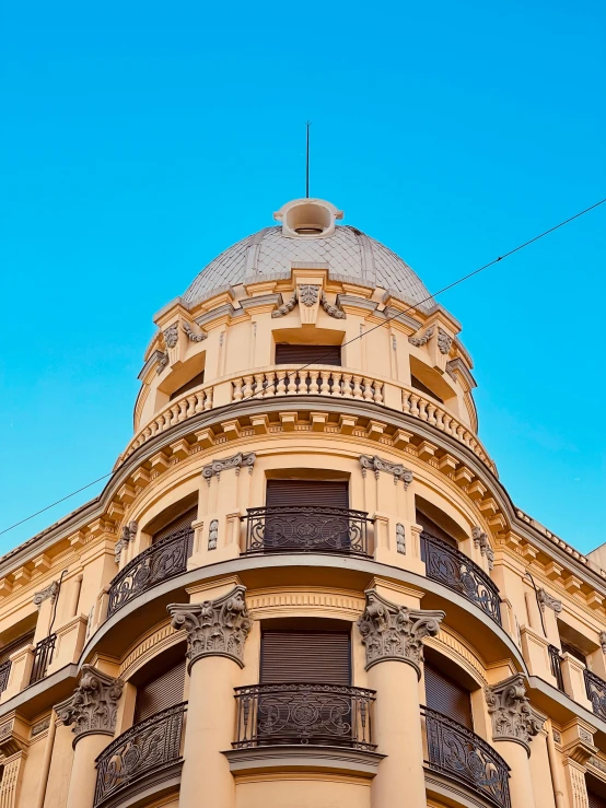 a brown building with a sky background